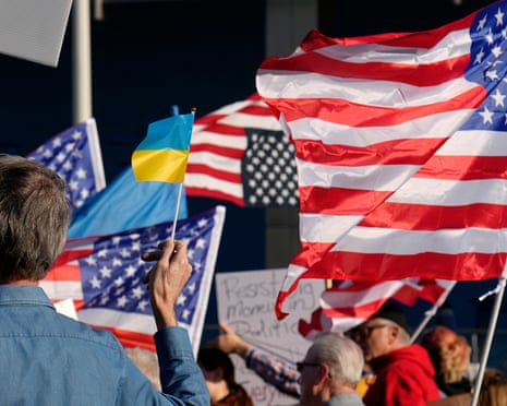Flags fly in the wind during a protest against the Trump administration in Cleveland.