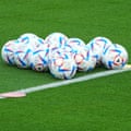 Qatar World Cup soccer balls on the pitch.