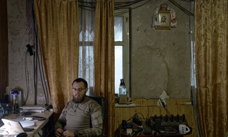 A Ukrainian soldier sits above the icon at his workplace in Avdievka on December 23.