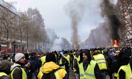 Thousands of protesters stage a demonstration against rising fuel prices in the Champs Élysées in Paris