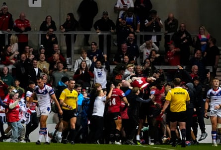 Salford fans come on to the pitch in frustration after Jack Walker scores near the end of their 52-16 defeat by Wakefield.