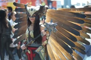 A cosplayer dressed as Hawk Girl poses for a photograph