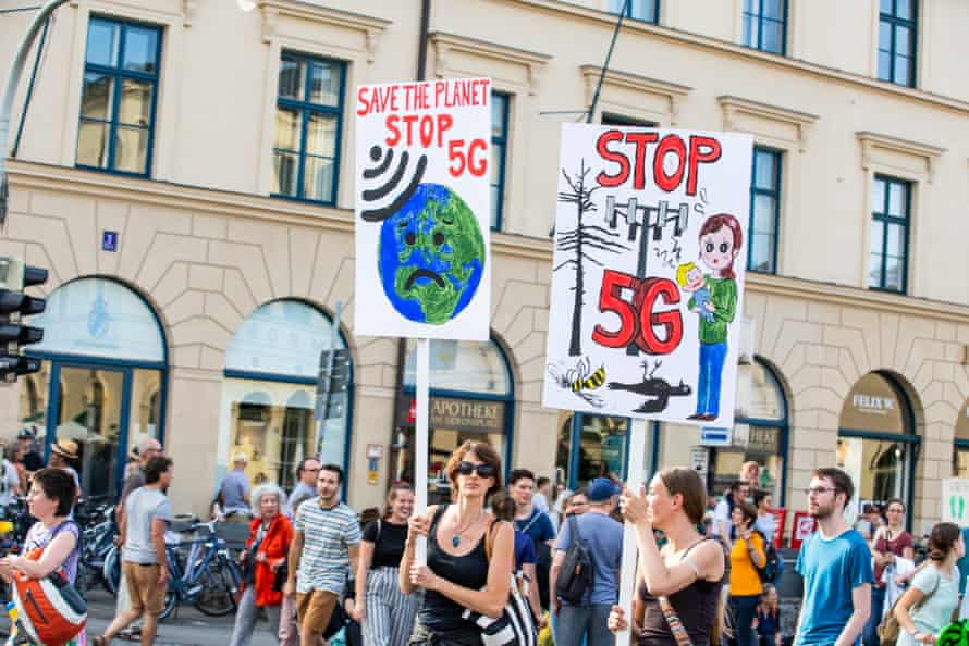 Protesters hold signs opposition 5G at a climate change rally in Munich, Germany.
