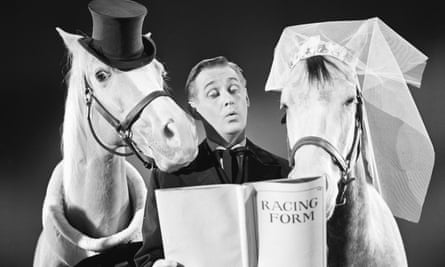 Alan Young reads from the racing form as the minister at a wedding between Bamboo Harvester and Rosita in the episode Ed the Bridegroom in 1965.