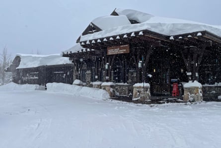 A one-story lodge covered in snow.
