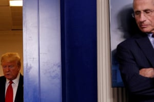 Donald Trump arrives behind Dr Anthony Fauci for a coronavirus taskforce briefing at the White House on 31 March.