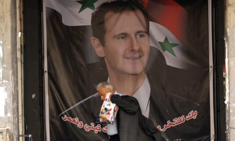 A man walks past a portrait of Syrian president Bashar al-Assad on a street in Damascus.