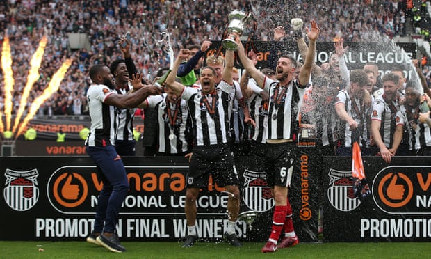 Grimsby Town celebrate promotion to League Two after defeating Solihull Moors at the London Stadium in early June.