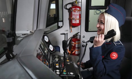 A female train driver uses the phone inside the cab of a train in the maintenance depot on Line 4 (Filyovskaya Line) of the Moscow Underground (Metro). 