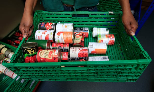 A crate of tinned tomatoes at a food bank