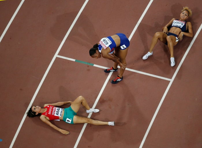 Rababe Arafi, left, lies on the track beside Shelayna Oskan-Clarke, centre, and Renelle Lamote after the women’s 800m final