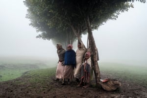 Children stand under a tree on the site of a future camp for Eritrean refugees near the village of Dabat