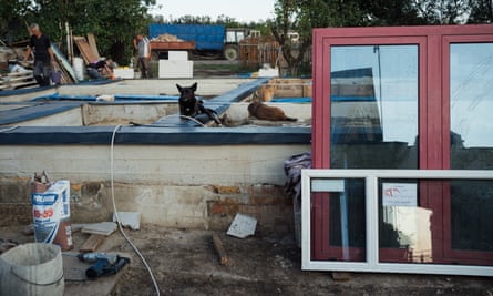 A pink recycled window from Polish NGO Unity and Strength as seen in front of a house construction for Korniicha family in Kamianka, Kharkiv region on 18 September 2023.