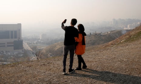 An Iranian couple takes a selfie in tehran