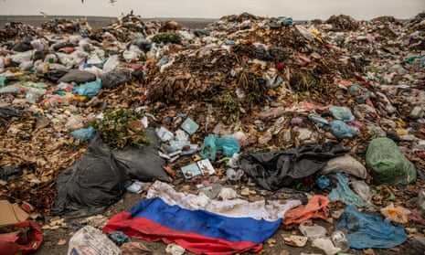 A Russian flag in the mud of the Kherson landfill.