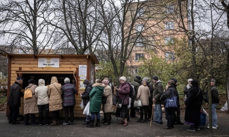 Pensioners queue for free soup, bread and hot food handed out at a stand run by a charity in Kyiv, Ukraine.