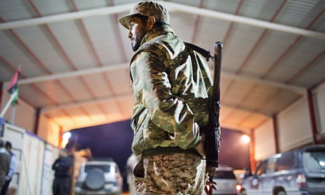 A Libyan soldier stands guard 68 miles from Isis-occupied Sirte.