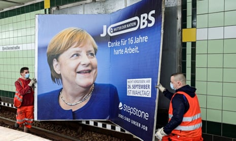 Workers remove an advertisement showing German chancellor Angela Merkel with a slogan that reads ‘Mother of Nation – Thanks For 16 Years of Hard Work’ before this weekend’s elections in Hamburg.