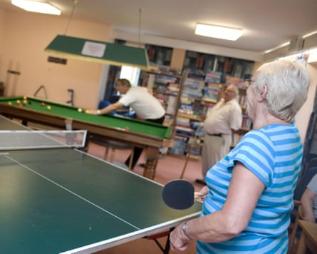 Elderly residents of a care taking part in activities to maintain mobility and for companionship.