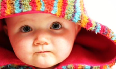 Baby in colourful fleece hooded poncho