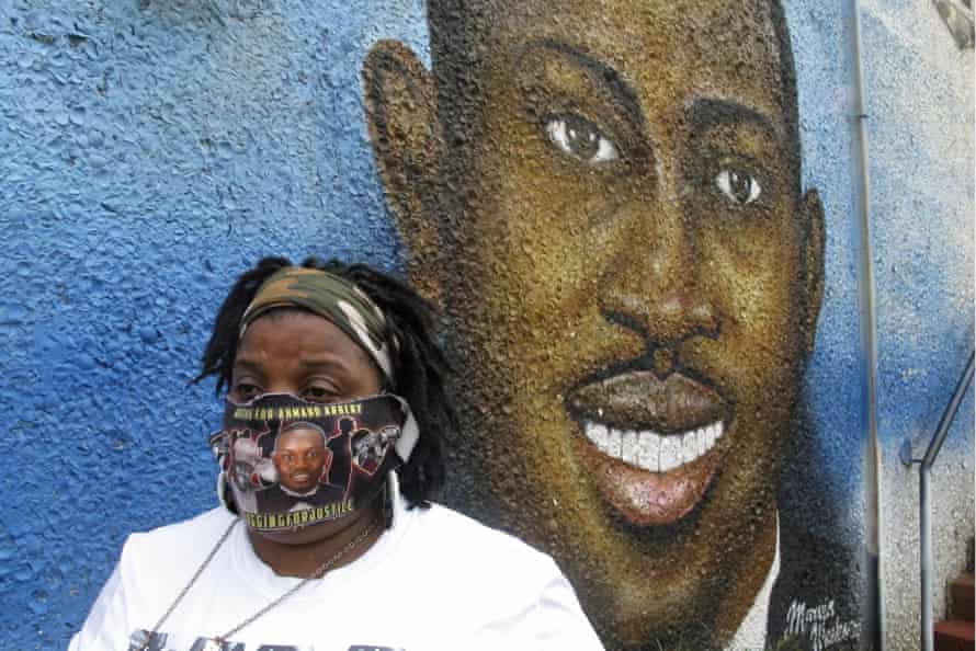 Thea Brooks stands in front of a mural of her nephew Ahmaud Arbery, in Brunswick, Georgia. Brooks calls the killing a ‘modern-day lynching’.