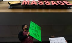 Jesus Estrella holds a sign of solidarity outside Youngs Asian Massage where four people were shot and killed on 17 March in Acworth, Georgia. 