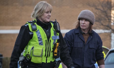 Sarah Lancashire in police uniform and a hi-vis gilet, with Susan Lynch in overalls and wearing a beanie.