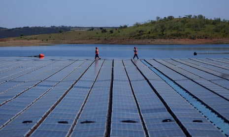Workers install Europe’s largest floating solar farm on a dam in Moura, Portugal, last year.