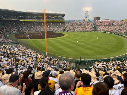Spectators try to keep cool during a recent match between the Hanshin Tigers and Yomiuri Giants at Koshien baseball stadium near Osaka, Japan