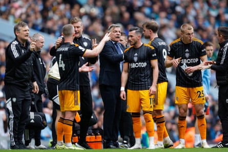 Leeds United manager Sam Allardyce and his coaching team speak to the players during a break in play during the Premier League match between Manchester City and Leeds United at Etihad Stadium.