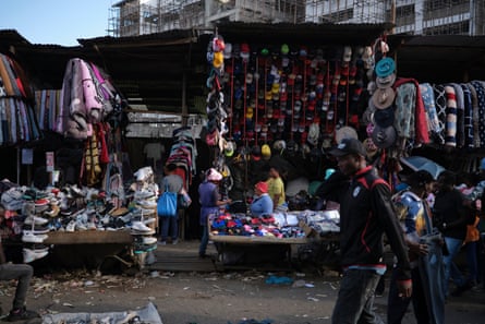 Stalls piled high with shoes and hats.