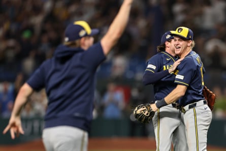 Cooper Pratt and Brice Turang embrace after Milwaukee defeated Tampa Bay in Game 5 of the World Series on Wednesday night.