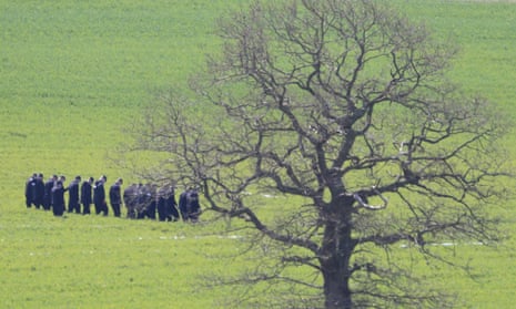 Police search a field