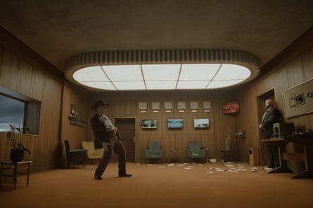 Tom Cruise as Digger Rockwell dances in a retro wood-panelled room with armchairs and clocks