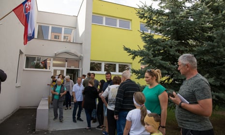 Voters wait in line to cast their ballots at a polling station in Slovak parliamentary elections in Pezinok.