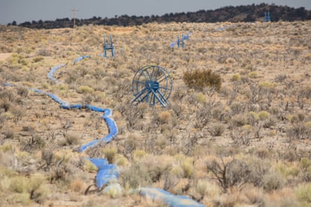 A fracking water hose runs through the desert and connects with a fracking operation on Navajo trust land north of Chaco Culture national park.