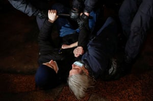 Two demonstrators are held down by police during the St Petersburg protest.