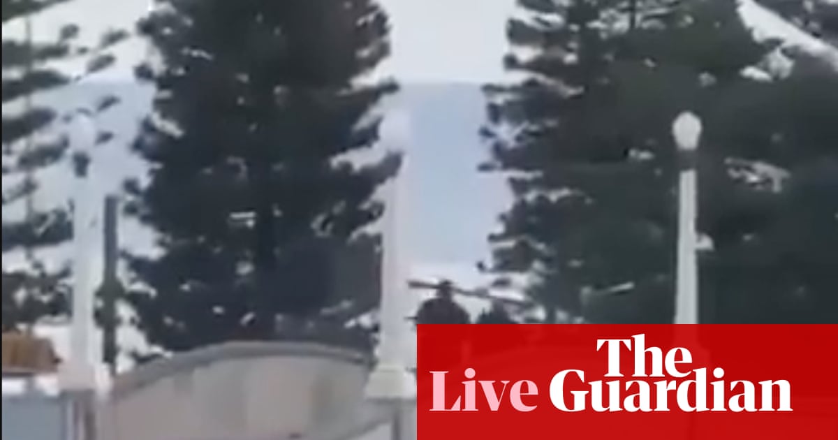 Bondi beach shooting live updates: two people in custody as PM urges public to follow police guidance amid shocking and distressing' scenes