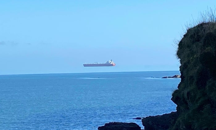 Walker 'stunned' to see ship hovering high above sea off ...