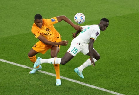 Netherlands' Denzel Dumfries in action with Senegal's Krepin Diatta.
