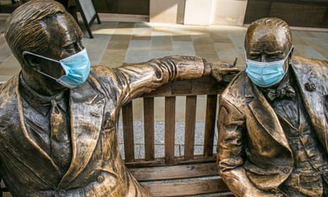 A sculpture featuring wartime leaders Winston Churchill and Franklin Roosevelt wearing protective facemasks in London.
