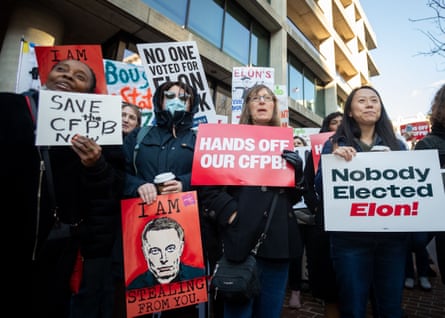 people hold placards at a demonstration