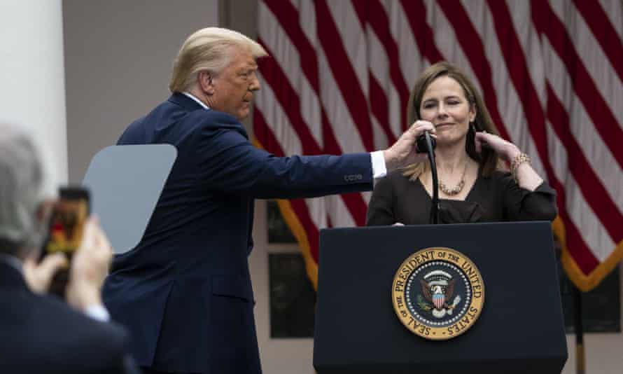 Trump adjusts the microphone after he announced Barrett as his supreme court nominee.