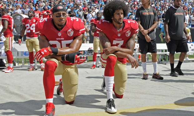Colin Kaepernick (right) and Eric Reid kneel during the national anthem before the 49ers’ game against the Panthers
