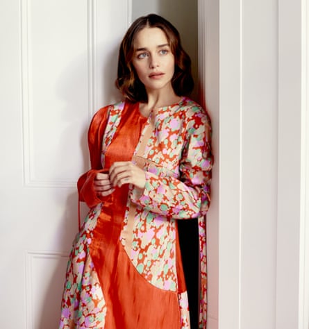 ‘I help provide relief. And that’s worth something’: Emilia Clarke wears an orange silk dress by rejinapyo.com