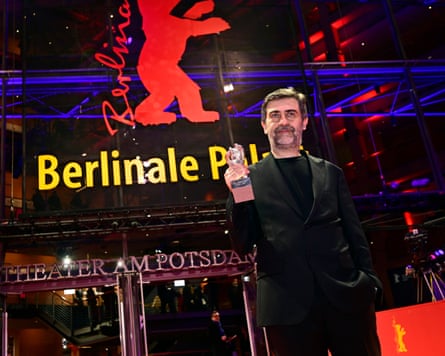 Director Emin Alper poses with the Silver Bear Grand Jury Prize at the closing ceremony of the 76th Berlin International Film Festival