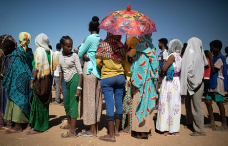 Refugees queue for food distribution in Um Rakuba refugee settlement in Eastern Sudan.