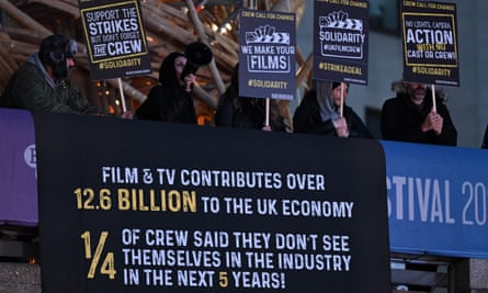 Protesters hold placards
