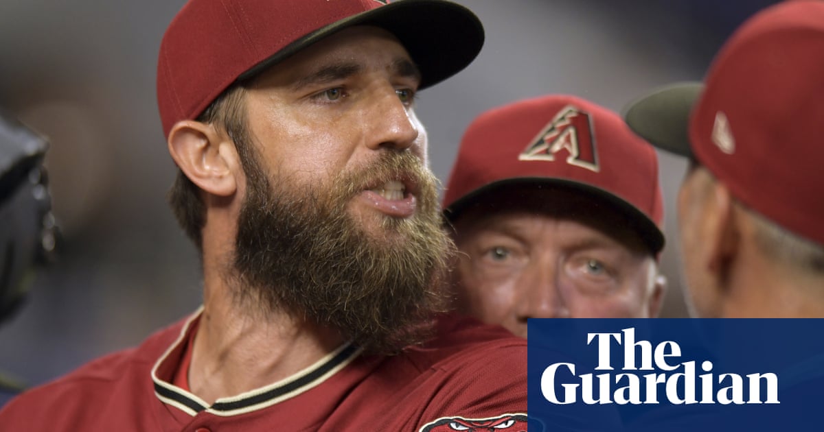 Arizona’s Madison Bumgarner held back by teammates after first-inning ejection