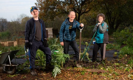 Steve Lewis, centre, with his son, James, and wife, Annette, on their allotment in Sheffield.